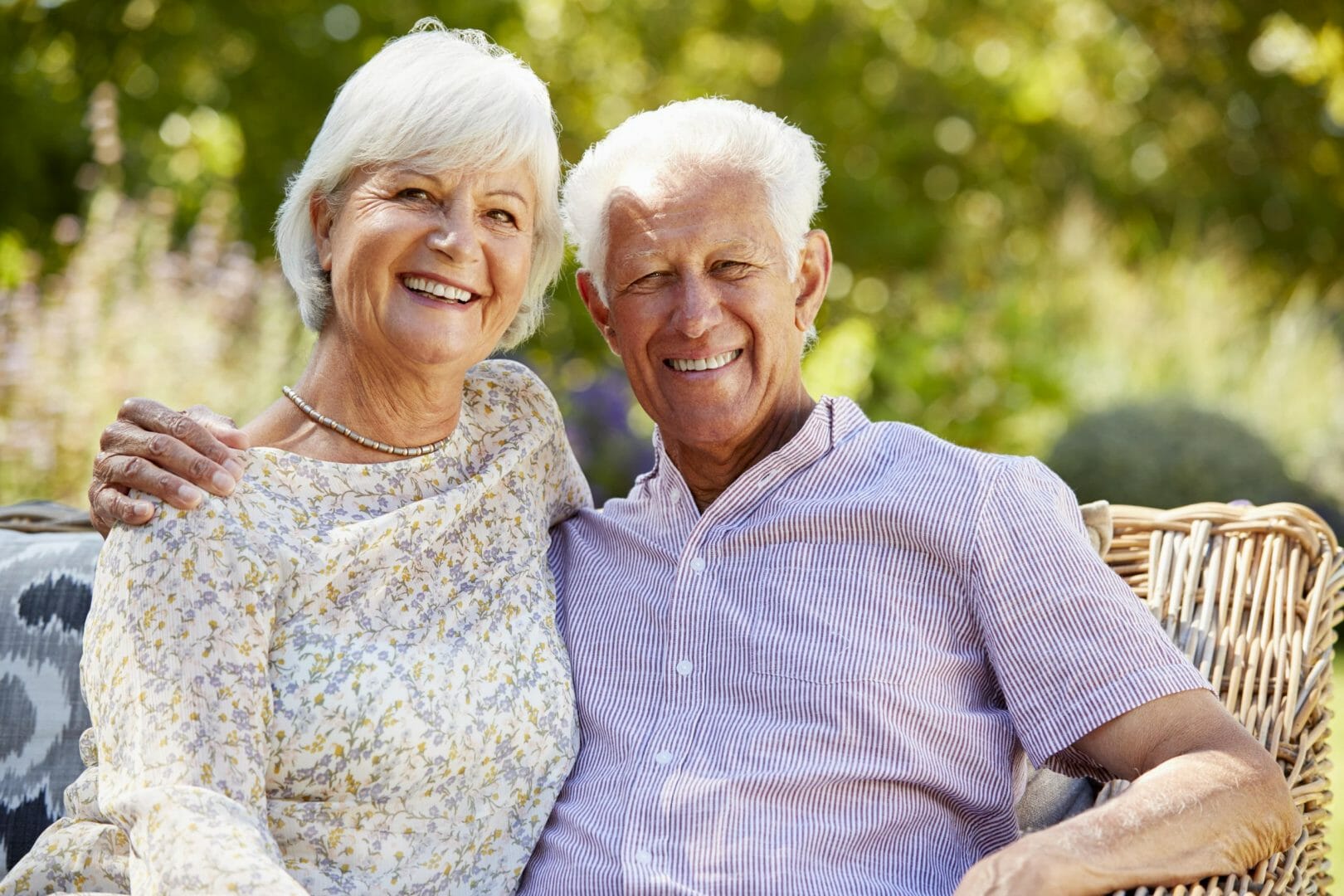 Keeping Your Teeth Bright after Teeth Whitening,Happy elderly couple sitting outdoors smiling