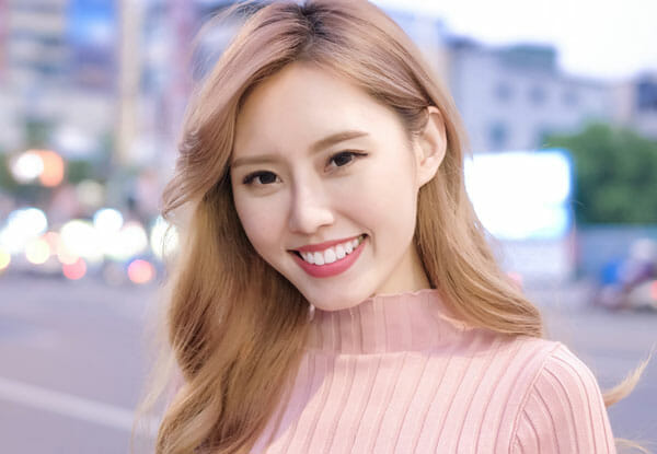 Smiling woman with long blonde hair outdoors